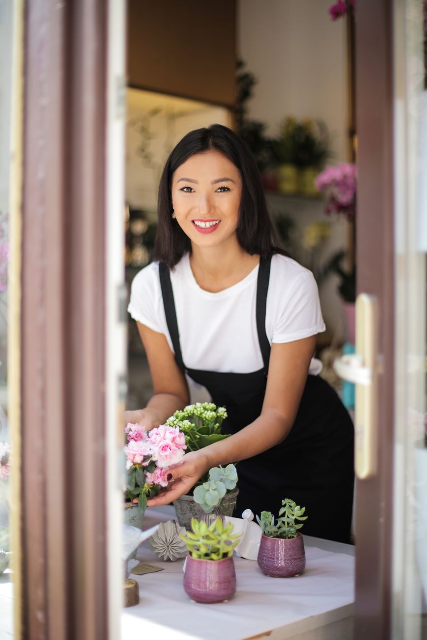 A florist arranging a bouquet in her shop