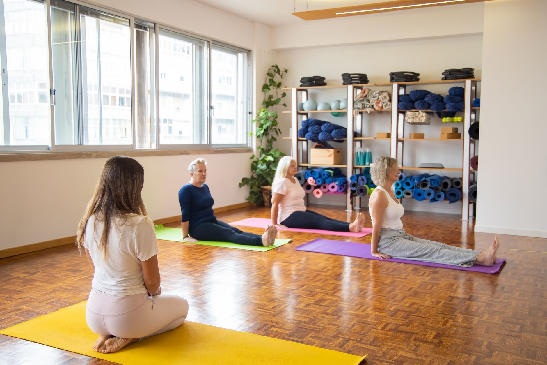 An instructor leading a class in a wellness studio